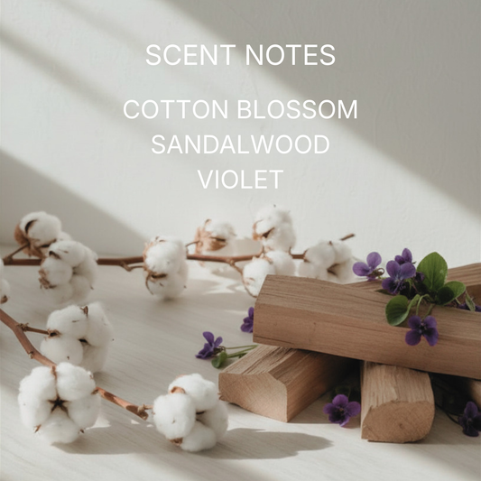 Cotton branches, sandalwood logs, and purple flowers on a light background with 'Scent Notes: Cotton Blossom, Sandalwood, Violet' text.