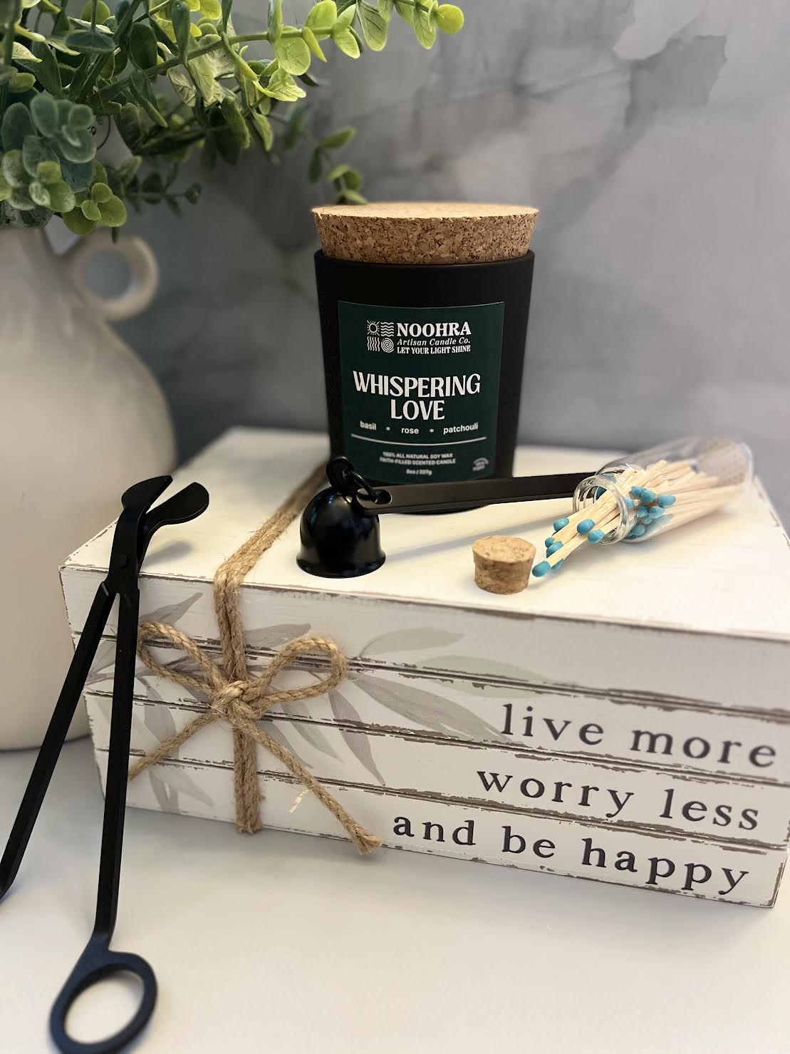 A candle with a label that says Whispering Love