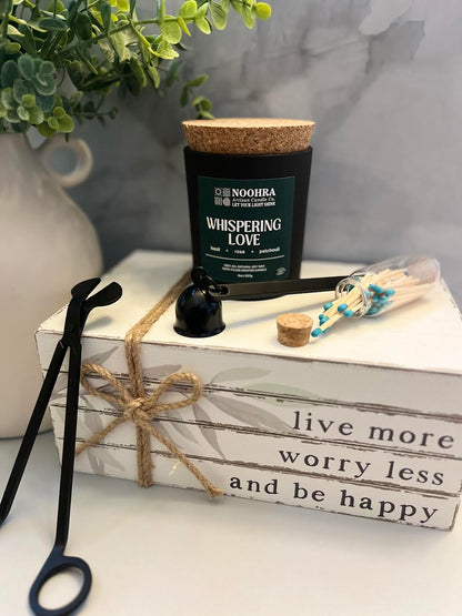 A candle with a label that says Whispering Love