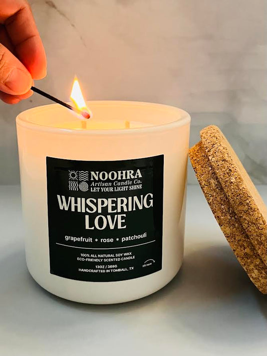 A candle that says Whispering Love