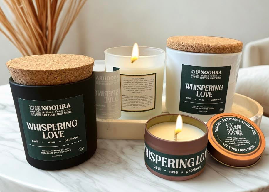 A candle with a label that says Whispering Love