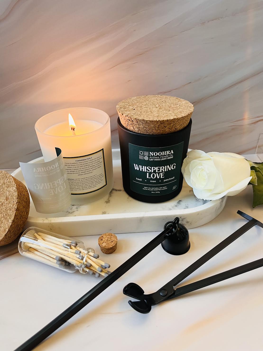 A candle with a label that says Whispering Love