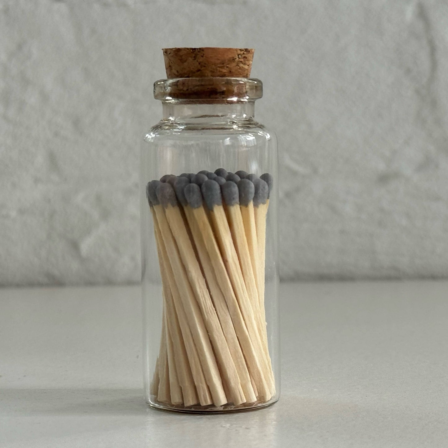 Match in a glass vial - gray