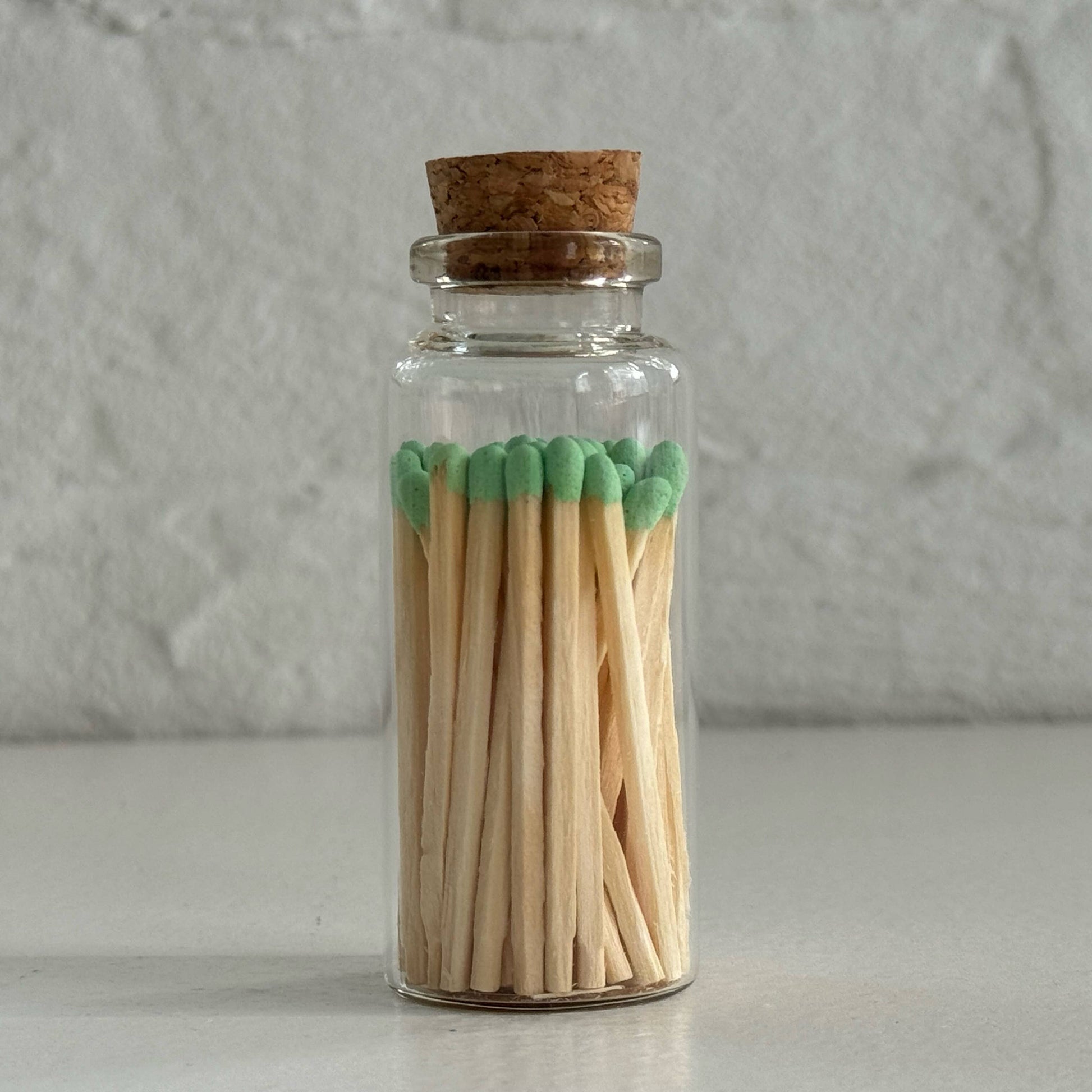 Match in a glass vial with cork - green