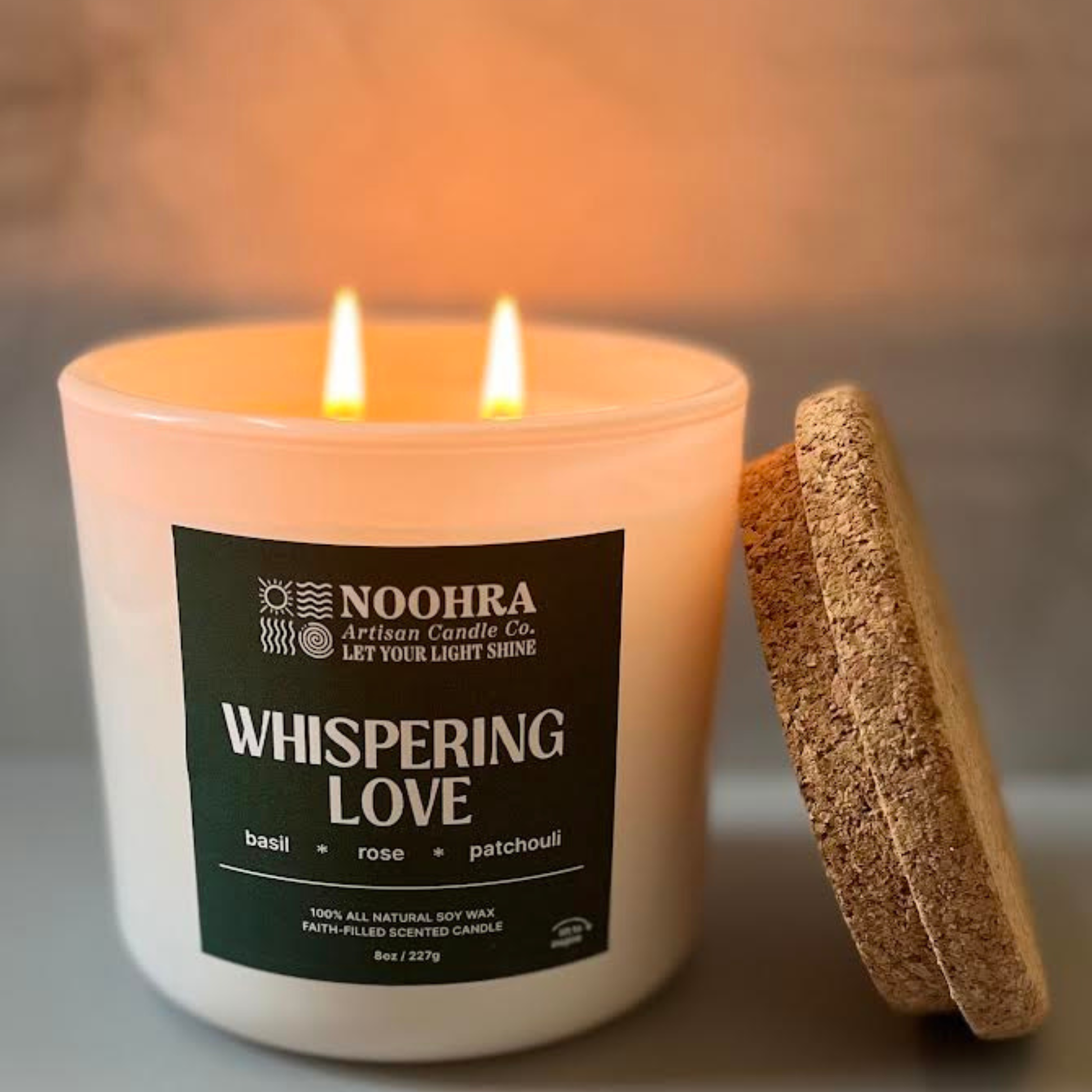A candle with a label that says Whispering Love