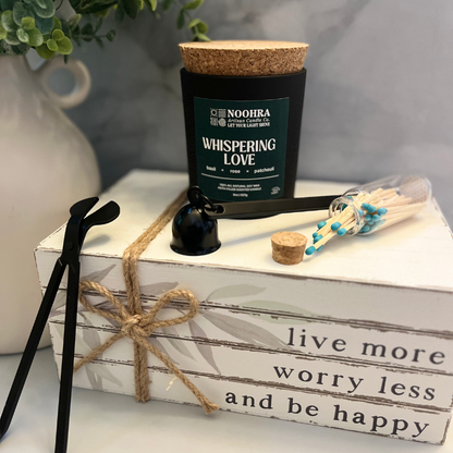 Matte black Wickman wick trimmer tool beside Noohra candle, styled for clean trimming and elegant care