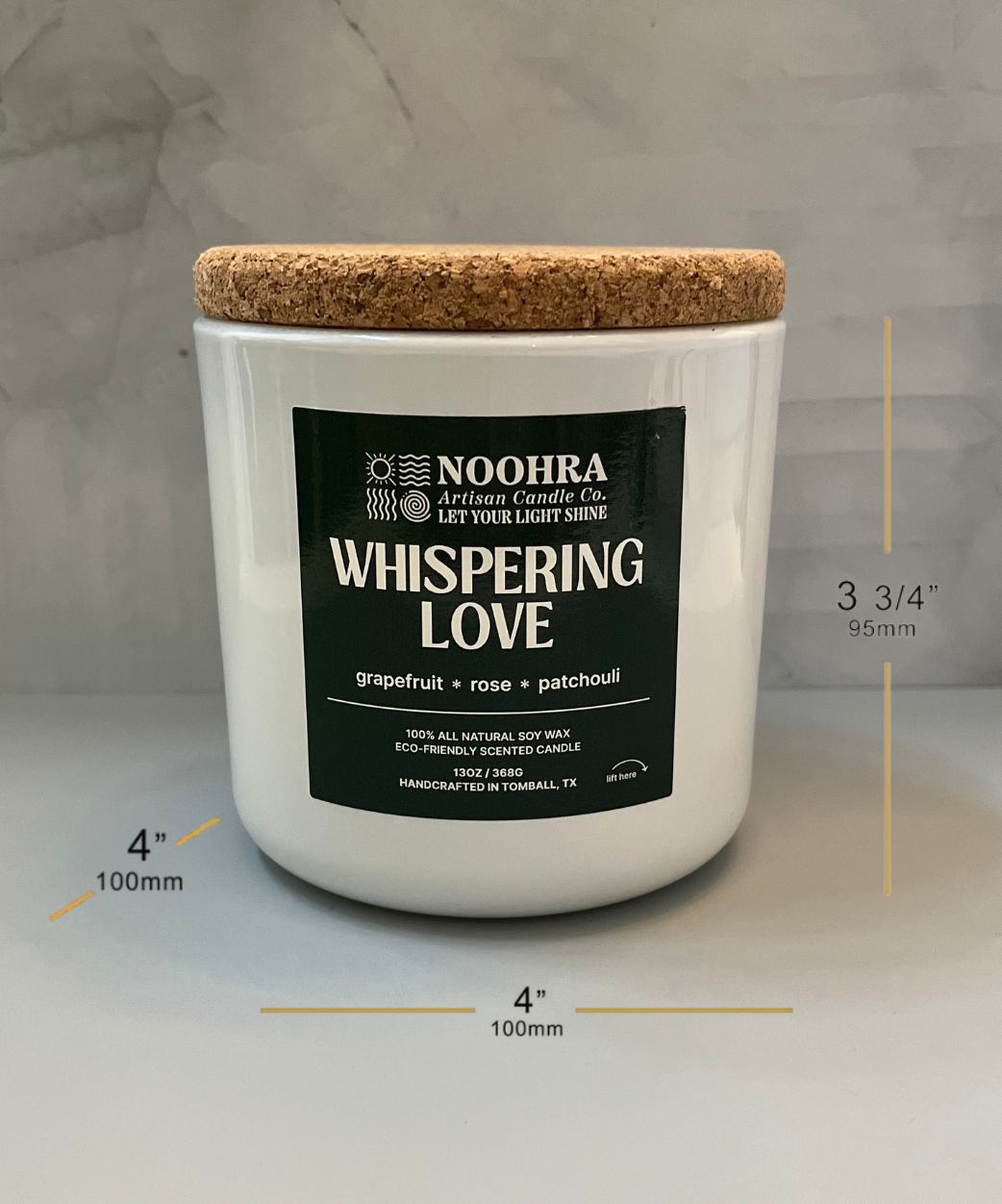 A candle that says Whispering Love