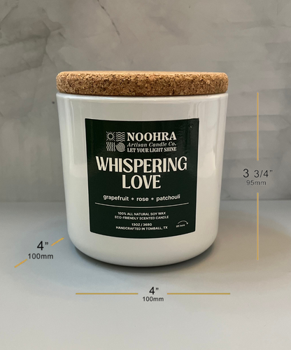 A candle that says Whispering Love