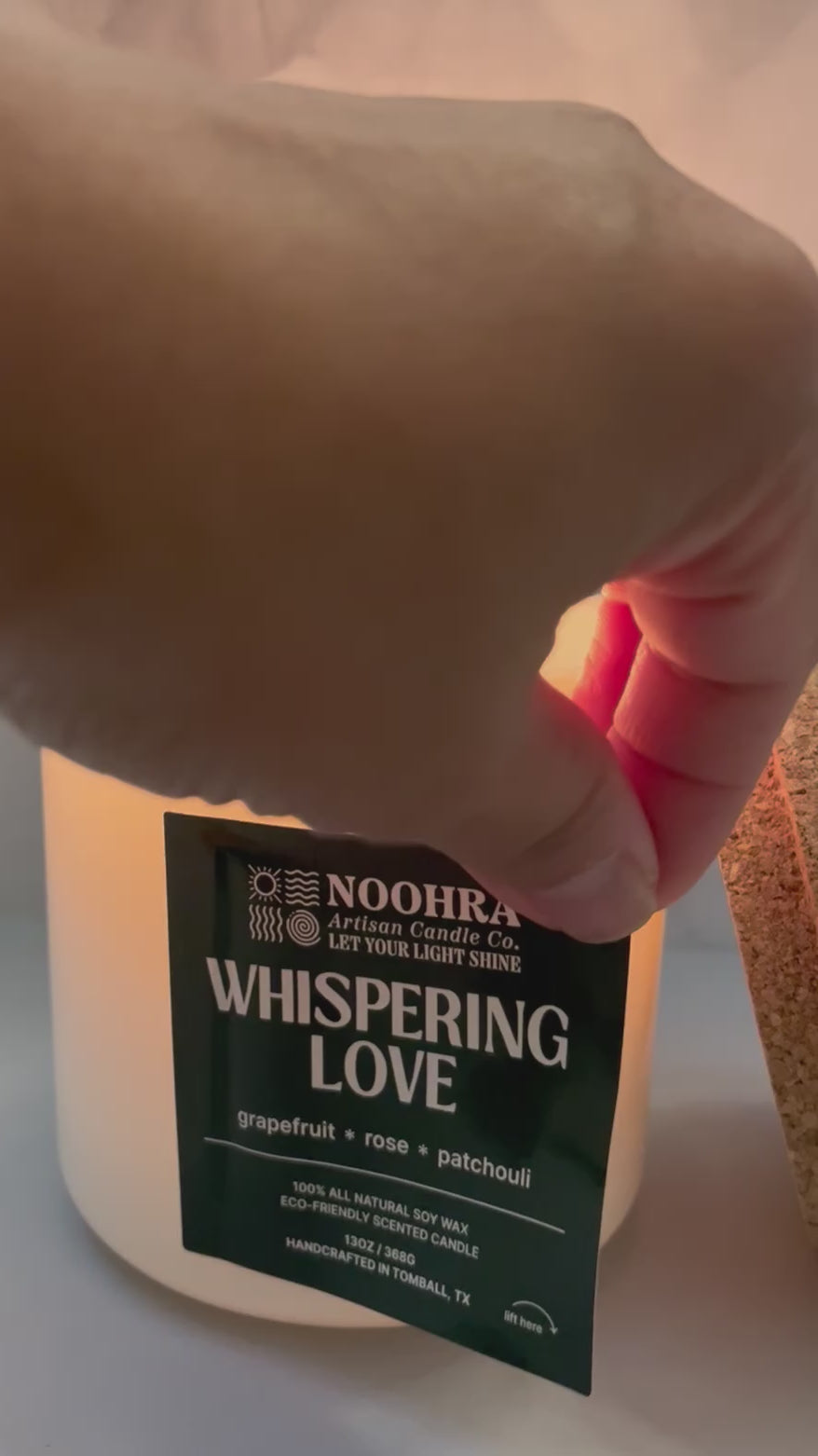 A candle that says Whispering Love